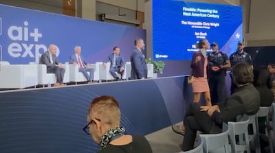 A protester is removed from the AI+ Expo in Washington