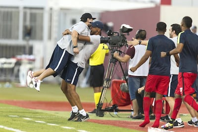 Diego Maradona, left, is hoisted in the air by Fujairah team manager Yousuf Abdullah after seeing his side take the lead against Al Orouba. Christopher Pike / The National