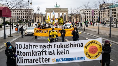 Anti-nuclear protesters in Berlin, Germany, with a banner reading '10 years after Fukushima nuclear power is not a climate saviour'. Getty