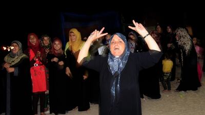 Relatives celebrate during the arrival of freed Palestinian prisoner Ateya Abu Moussa. AFP PHOTO / SAID KHATIB