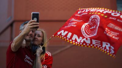 Liverpool fans celebrate outside Anfield stadium. EPA