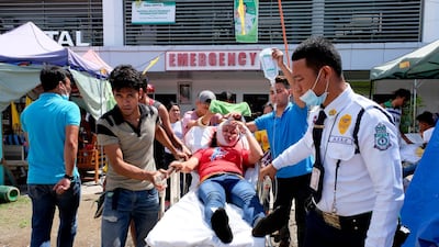 A woman is transferred to another hospital after she was injured following a quake that hit Digos, Davao del Sur, southern Philippines on Thursday Oct. 31, 2019. The third strong earthquake this month jolted the southern Philippines on Thursday morning, further damaging structures already weakened by the earlier shaking. (AP Photo/Romer S. Sarmiento)