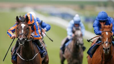 Ryan Moore riding Roly Poly, left, to a win in the Falmouth Stakes from Wuheida, right in blue, at Newmarket on July 14. Alan Crowhurst / Getty Images