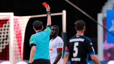 Leipzig's Dayot Upamecano is shown a red card by referee Deniz Aytekin. EPA