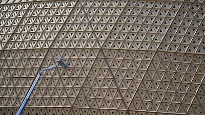 A man works on the facade of the Lusail Stadium in Doha. AFP