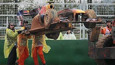 Mark Webber’s Red Bull-Renault is lifted from the track after his crash yesterday.