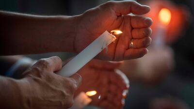 People light candles during a prayer and candle vigil organized by the city, after the shooting that left 20 people dead at the Cielo Vista Mall WalMart in El Paso, Texas, on August 4, 2019. AFP