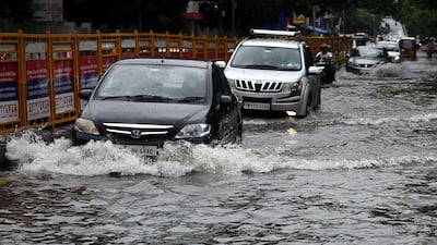 Motorists brave deep water on Chennai's roads. AFP