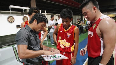Manny Pacquiao coaches his basketball team in General Santos in late 2013. Mike Young for The National / November 16, 2013