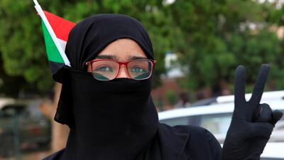 A Sudanese woman waves their national flag and flashes a victory sign during celebrations of the signing of the Sudan's power sharing deal. REUTERS/Mohamed Nureldin Abdallah