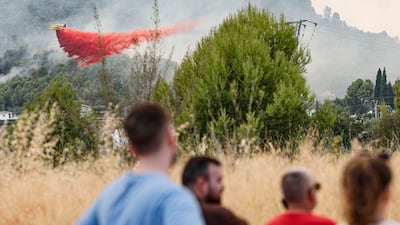 A hydroplane sprays water to extinguish a fire in Betxi, Castellon. EPA