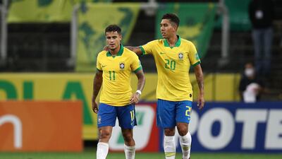 Philippe Coutinho of Brazil celebrates with Roberto Firmino after scoring the fifth goal. Getty