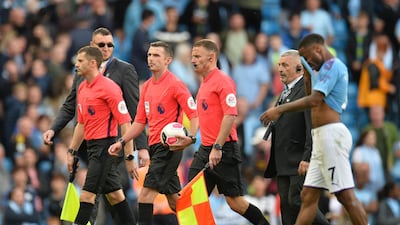 Referee Michael Oliver (3-L) leaves the pitch at the end of the English Premier League soccer match between Manchester City and Tottenham Hotspurs at the Etihad Stadium in Manchester, Britain. EPA
