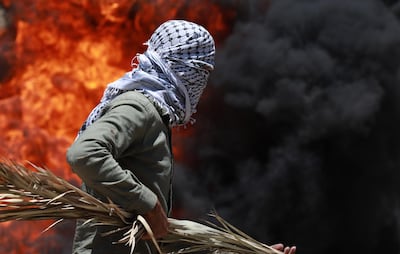 A Palestinian protester enveloped in billowing smoke originating from smoke grenades during a demonstration against Israel's plans to annex parts of the occupied West Bank, near Nablus, Palestine on June 12, 2020. EPA