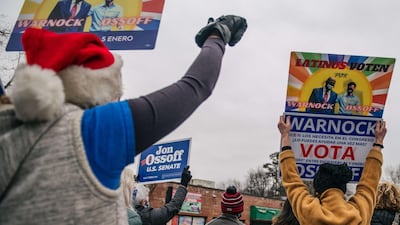 People cheer during a Latino meet and greet and literature distribution rally in Marietta, Georgia. AFP