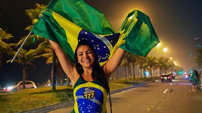 A supporter of Jair Bolsonaro celebrates outside his home in Rio de Janeiro. AFP