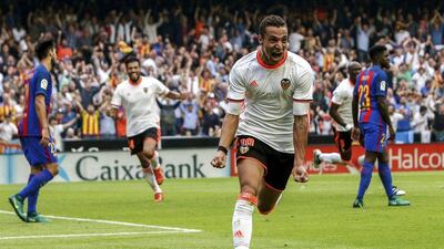 Valencia’s Rodrigo Moreno, centre, celebrates after scoring for the 2-1 lead. Biel Alino / EPA