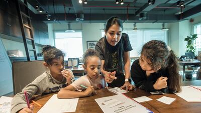 Mishael Al Shamsi, 9, Mariam El Tohamy, 8, and Lama Al Khouri, 10, learn how to spend and save money wisely at a financial literacy boot camp run by The Kids Finance Initiative. Leslie Pableo / The National