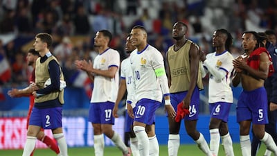 Kylian Mbappe walks off the field with teammates at the end of the friendly football match between France and Canada. AFP