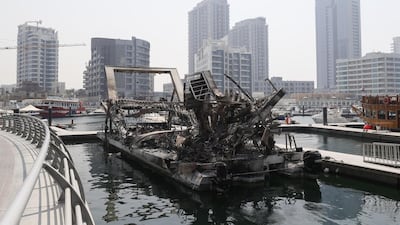 The burnt-out shell of the Waterworld restaurant remains at its mooring in Dubai Marina almost a month after it caught fire. Antonie Robertson / The National