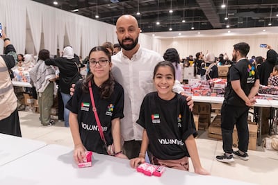 Ayman Al Souq packing aid for Palestine with his daughters Kindah and Jude in Dubai on Saturday. Antonie Robertson / The National