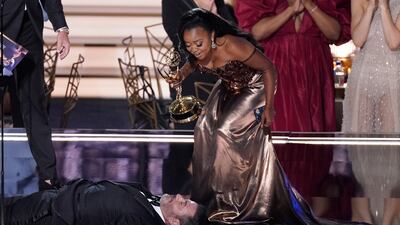 Quinta Brunson, right, winner of the Emmy for Outstanding Writing for a Comedy Series for 'Abbott Elementary', checks on Jimmy Kimmel. Photo: AP