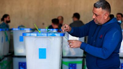 Employees of Iraq’s Independent High Electoral Commission conduct a partial manual recount in Baghdad of votes for the October 10 parliamentary elections on November 23, 2021. AFP