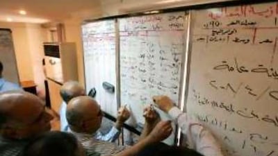 Emerging market: Iraqis buy and sell using a whiteboard at the stock market in central Baghdad.