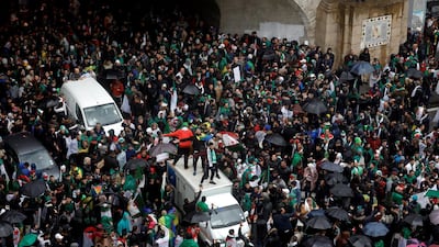 Demonstrators holding umbrellas take part in a protest calling on Algerian President Abdelaziz Bouteflika to quit, in Algiers on March 22, 2019. Reuters