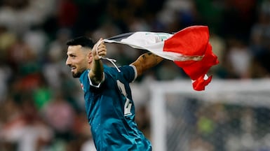 Iraq's Rebin Sulaka celebrates with the national flag after the 2-1 win over Bolivia in Monterrey, Mexico. Reuters