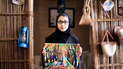 Maitha Bin Sarm, 13, holds a painting she created, as part of the summer programme organised before the pandemic by The Ministry of Culture, Youth and Community Development in Um Al Quwain. Reem Mohammed / The National