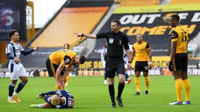 Referee Michael Oliver awards West Bromwich Albion their first penalty after Callum Robinson is fouled by Wolves defender Willy Boly. Getty