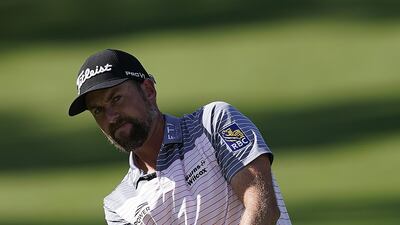 Webb Simpson of the US chips on the seventh hole. EPA