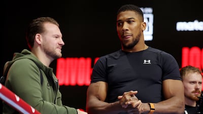Anthony Joshua speaks to his head coach Ben Davison during the media workout ahead of his heavyweight fight against Otto Wallin at the Kingdom Arena in Riyadh, Saudi Arabia, on Saturday, December 23, 2023. AFP