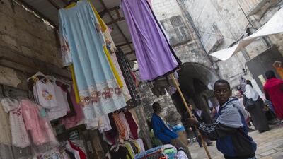 An Afro Muslim boy working in his family’s clothing stall which is located along one of the main routes to the Al Aqsa Mosque in the Old City of Jerusalem on March 4, 2016.