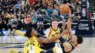 Utah Jazz guard Donovan Mitchell and Denver Nuggets guard Jamal Murray fight for the loose ball during the second half at Vivint Smart Home Arena. Chris Nicol / USA TODAY Sports