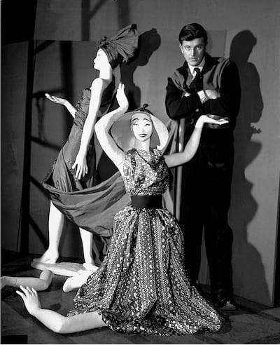 French fashion designer Hubert de Givenchy poses with mannequins in his shop in Paris. AP