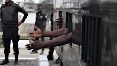 A protester reaches out from a mobile police cell after his arrest. EPA