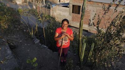 Maria del Pilar Condorcule in her organic garden in Gosen City. Condorcule reclaimed the land for her garden from a garbage dump and is now planting vegetables with her neighbours. Mariana Bazo / Reuters
