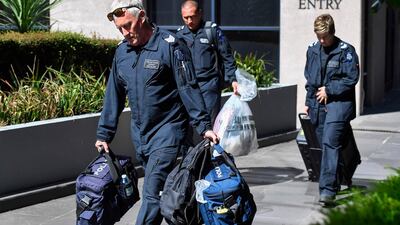 Victoria Police forensic officers remove a bag from the Italian consulate in Melbourne on Wednesday. AFP