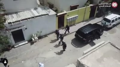 Abu Dhabi and Ajman Police teamed up to swoop on a gang leading a cold call scam operation in Ajman. Courtesy Abu Dhabi Police