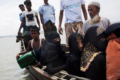 Myanmar's Rohingya ethnic minority use a local boat to cross a stream after crossing over to the Bangladesh side of the border near Cox's Bazar's Dakhinpara area on September 2, 2017. Thousands of Rohingya Muslims have poured into Bangladesh, part of an exodus of the beleaguered ethnic group from neighbouring Myanmar that began when violence erupted there on August 25. Bernat Armangue/AP Photo