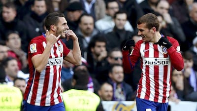 epa05183929 Atletico Madrid's French midfielder Antoine Griezmann (R) celebrates with Koke (L) after scoring the opening goal against Real Madrid during the Spanish Liga Primera Division soccer match played at Santiago Bernabeu stadium in Madrid, Spain, 27 February 2016. EPA/Ballesteros
