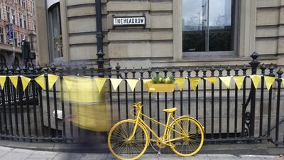 A man walks past a yellow bicycle prior the start of the 101st edition of the Tour de France 2014 cycling race in Leeds, Britain. The 190km-long first stage of the Tour de France 2014 starts 05 July from Leeds to Harrogate. Kim Ludbrook / EPA