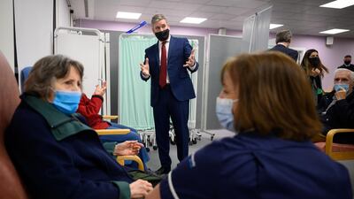 British Labour Party leader Keir Starmer speaks with people after they received the first of two vaccination shots in Stevenage. Reuters