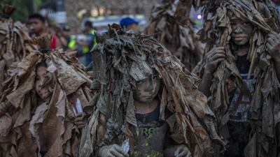 Devotees covered in mud and dried banana leaves take part in the Taong Putik ("mud people") Festival in the village of Bibiclat in Aliaga town, Nueva Ecija province, Philippines. Each year, the residents of Bibiclat village in Aliaga town celebrate the Feast of Saint John by covering themselves in mud, dried banana leaves, vines, and twigs as part of a little-known Catholic festival. Getty Images