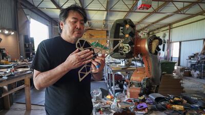 Mr Yuen displays a piece of metal that comes from part of a SpaceX rocket.
