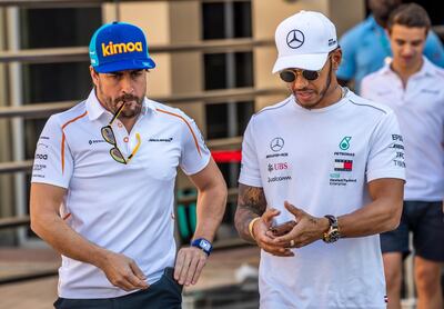 Hamilton walks with McLaren driver Fernando Alonso after a press conference. EPA
