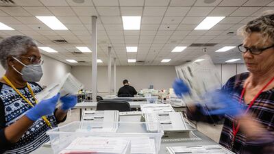 Election officials process ballots in Phoenix. Bloomberg