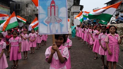 Schoolchildren in Mumbai, India, cheer the successful Moon landing by Chandrayaan-3. AP